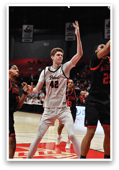 A basketball player with the number 42 on his jersey is trying to block a shot. AI generated content