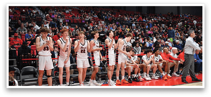 A group of young men are sitting on a bench, watching a basketball game. AI generated content