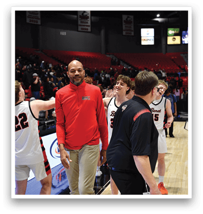 A group of people are standing on a basketball court, with one man in a red jacket walking towards the group. AI generated content