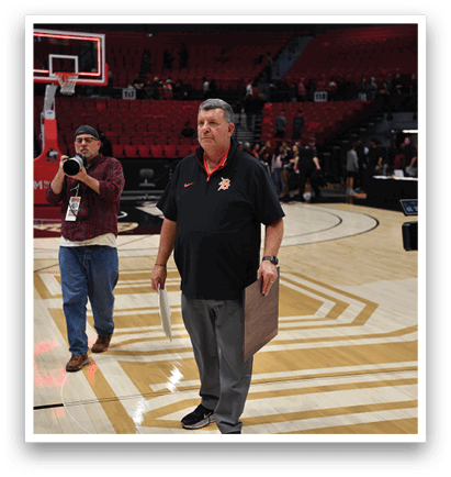 A man in a black shirt and jeans is walking on a basketball court. AI generated content