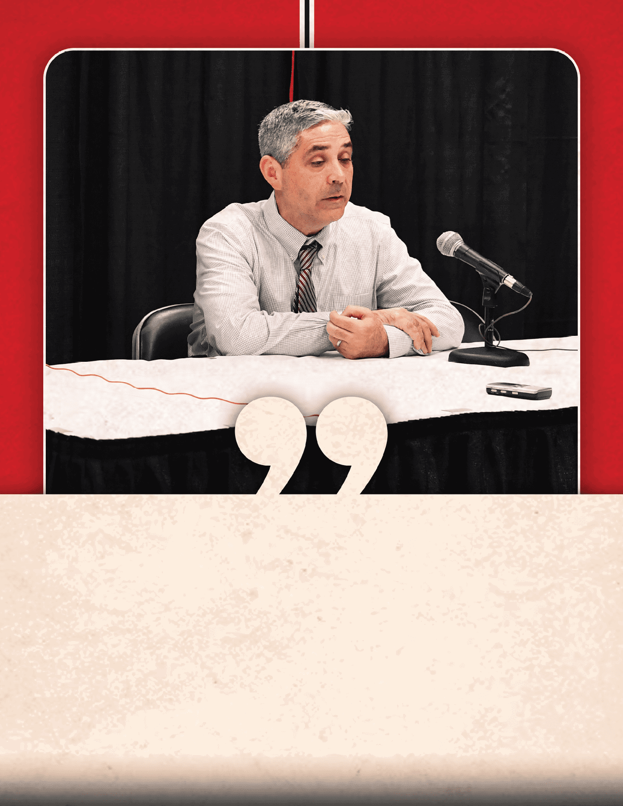 A man is sitting at a table with a microphone in front of him. AI generated content
