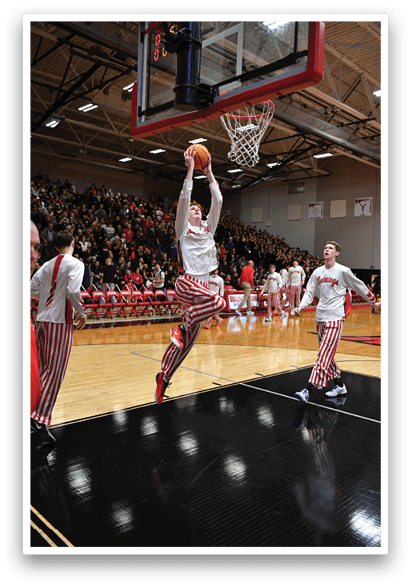 A basketball player is jumping in the air to dunk the ball. AI generated content