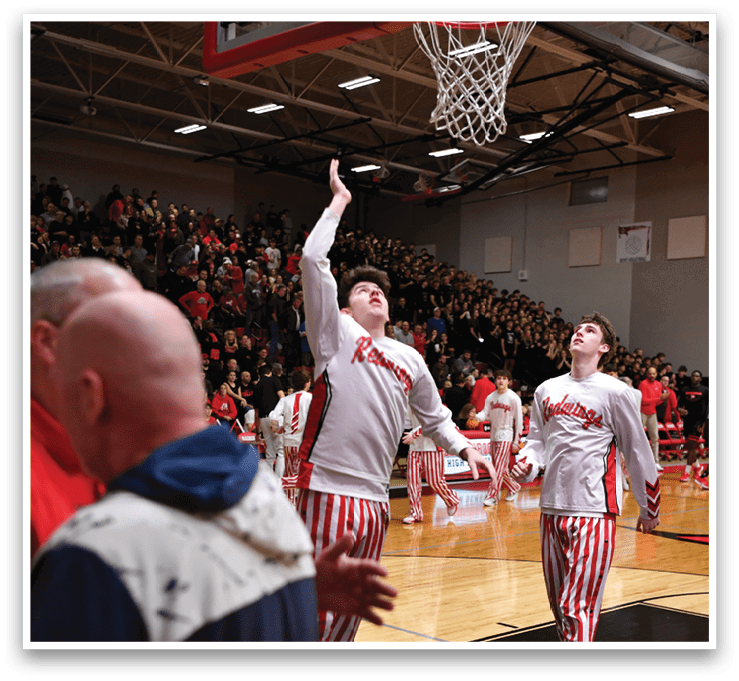 Two men wearing red and white striped pants are playing basketball. AI generated content
