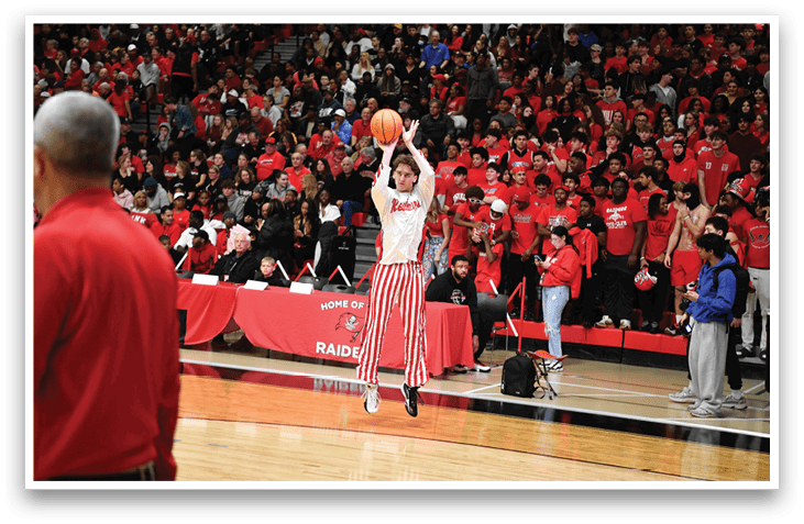A man is jumping in the air to catch a basketball while a crowd of people watch. AI generated content