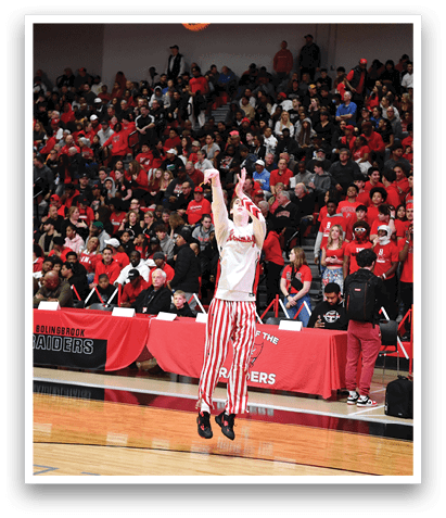 A man wearing a red and white striped shirt is dunking a basketball in front of a crowd of people. AI generated content