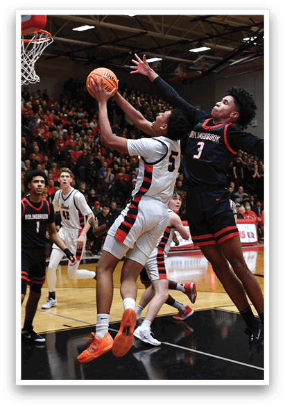 A group of basketball players on a court, one of them is attempting to block a shot. AI generated content
