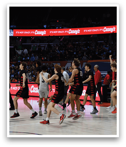 A group of young men celebrating a win on a basketball court. AI generated content
