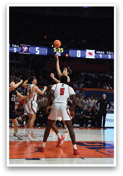 Basketball players on a court with a referee and a crowd watching. AI generated content