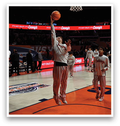 A basketball player is attempting to dunk the ball into the hoop. AI generated content