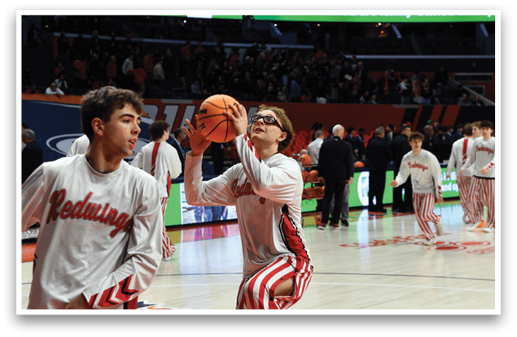 Two men in striped pants are playing basketball. One man is holding a basketball and the other is reaching for it. AI generated content