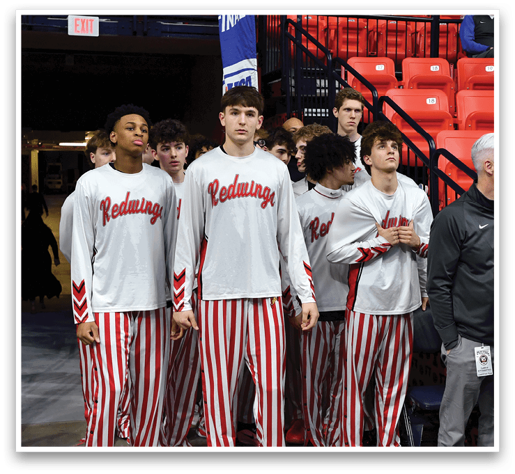 A group of basketball players wearing red and white striped pants stand on the court. AI generated content