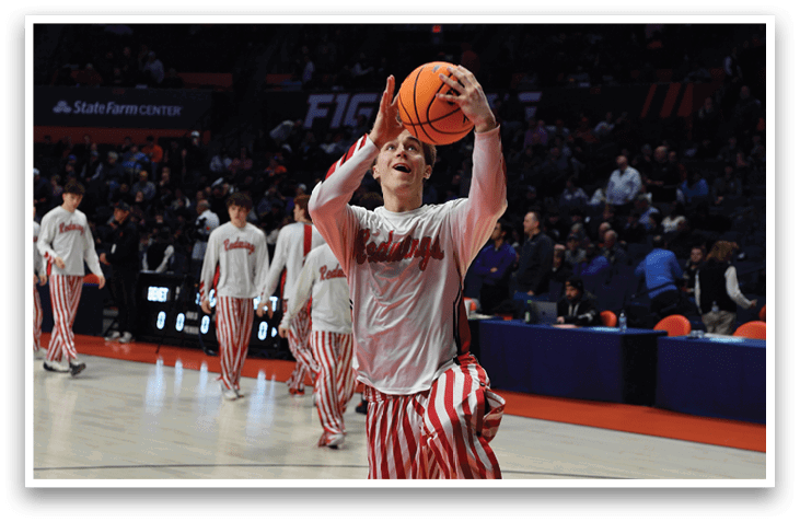 A man in a striped shirt and red shoes is holding a basketball and preparing to shoot it. AI generated content