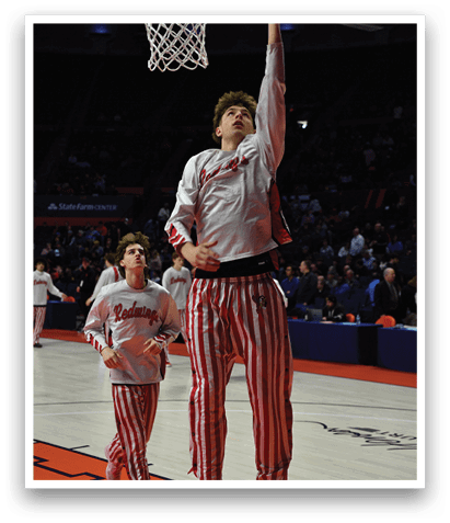 Two men wearing striped pants are playing basketball. AI generated content