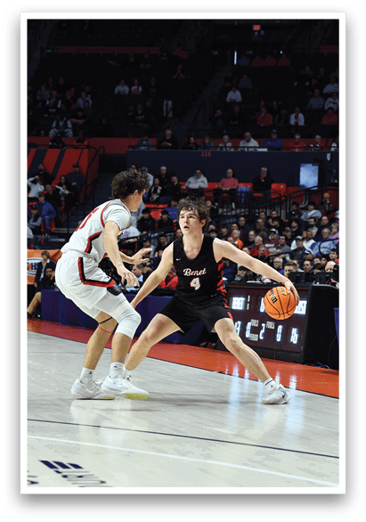 A basketball game is in progress with a player in a black shirt trying to steal the ball from another player. The crowd is watching intently as the players compete. AI generated content