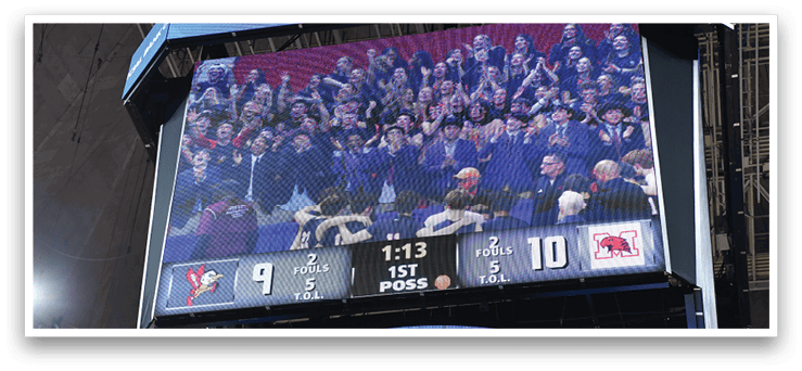 A large crowd of people are watching a game on a big screen. AI generated content