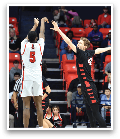 Two men are playing basketball, one is trying to block the other from getting the ball. AI generated content