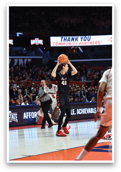 A basketball player is attempting to shoot a basket while being guarded by another player. AI generated content