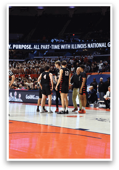 A group of basketball players huddle on the court. AI generated content