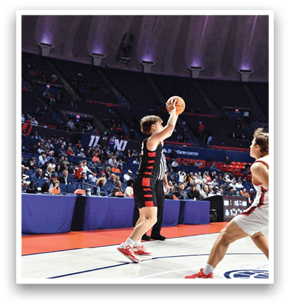 A man in a red jersey shoots a basketball while a man in a white jersey watches. AI generated content