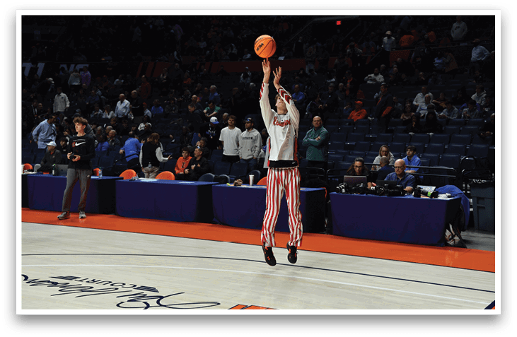 A man in a striped shirt and shorts is jumping to catch a basketball. AI generated content