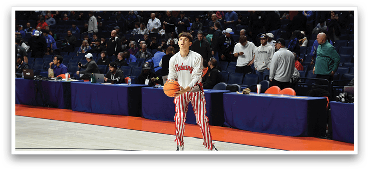 A young man in a white shirt and red and white striped pants holds a basketball. AI generated content
