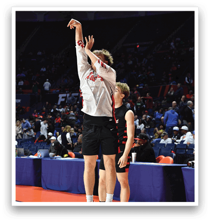 Two men playing basketball, one jumping up to catch the ball. AI generated content