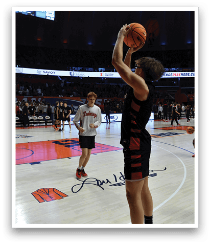 A basketball player in a red jersey is holding a basketball in the air, preparing to shoot. AI generated content
