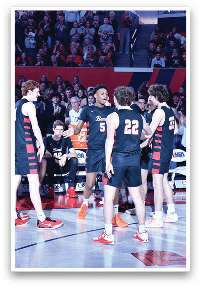 A group of basketball players huddle together on the court, with some players sitting on a bench. The crowd is watching the game, and the players are likely discussing their strategy or celebrating a point. AI generated content
