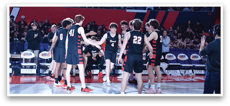 A group of young men wearing black and red uniforms are hugging each other on a basketball court. AI generated content