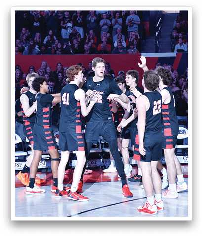 A group of men in black jerseys are celebrating on a basketball court. AI generated content