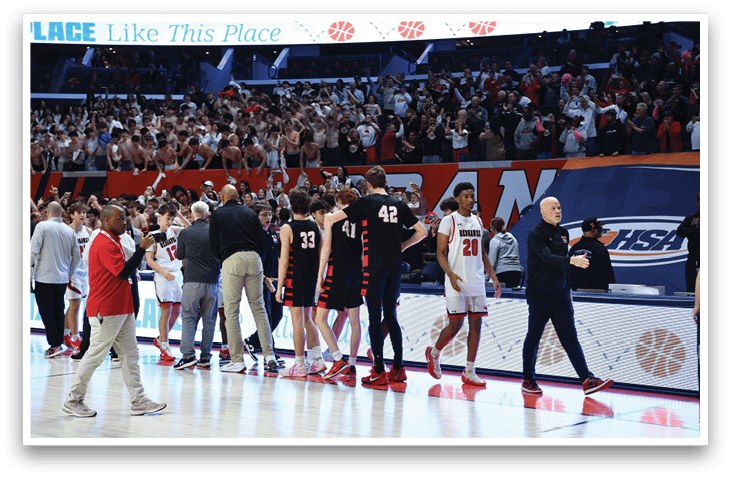A group of people are standing on a basketball court, some of them wearing red and white uniforms. They are shaking hands with each other, possibly after a game. AI generated content
