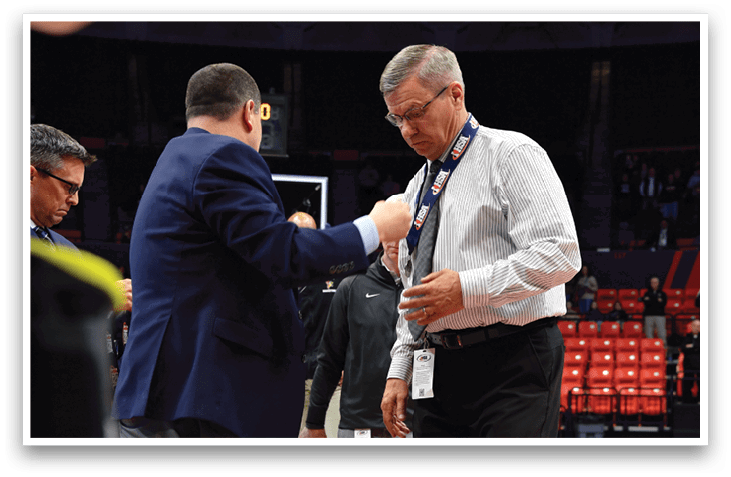 Two men shake hands on a basketball court. AI generated content