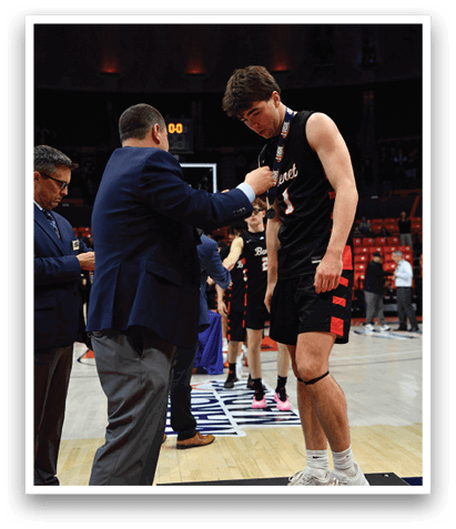 A man is getting his shoes shined by another man on a basketball court. AI generated content