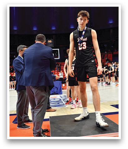 A man in a black shirt and shorts stands on a box while another man in a suit looks on. AI generated content