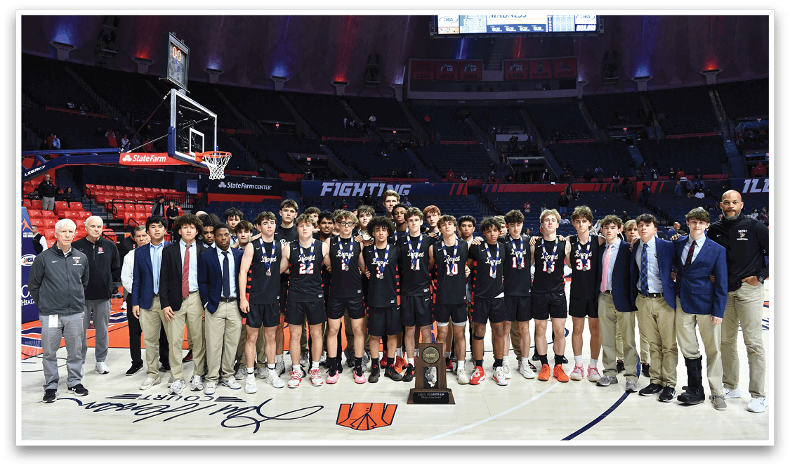 A group of young men in black and orange uniforms pose for a picture on a basketball court. AI generated content