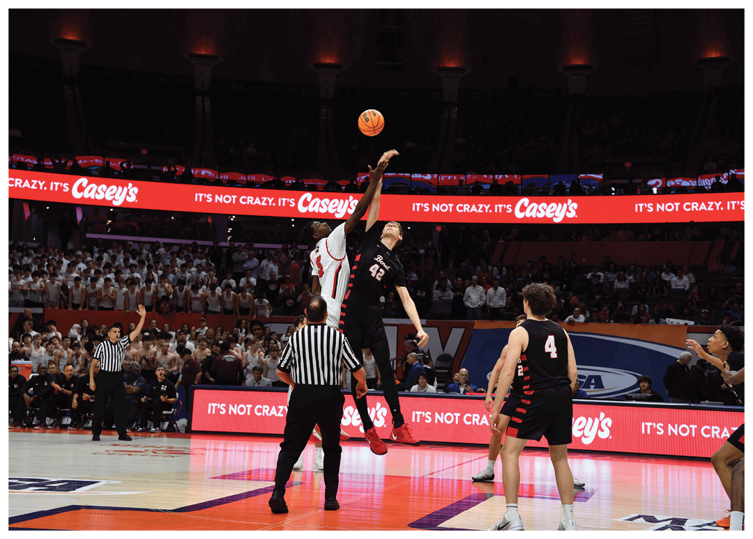 Basketball players on a court, one of them jumping to block a shot. AI generated content