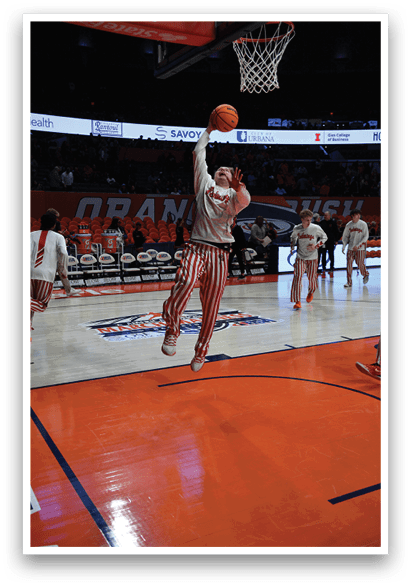 A basketball player in a red and white striped uniform is dunking a basketball through a hoop. AI generated content