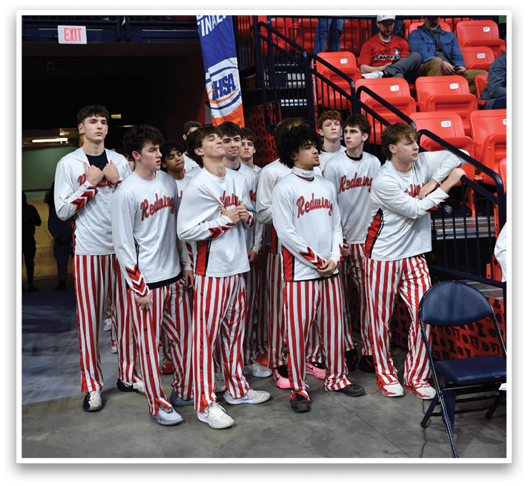A group of young men wearing striped pants and white shirts stand on a basketball court. AI generated content