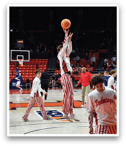 A group of basketball players are on the court, with one player jumping to catch a basketball. AI generated content