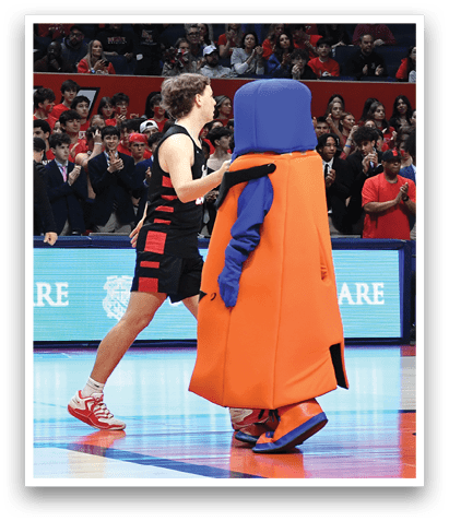 A mascot in an orange and blue costume stands on a basketball court. AI generated content