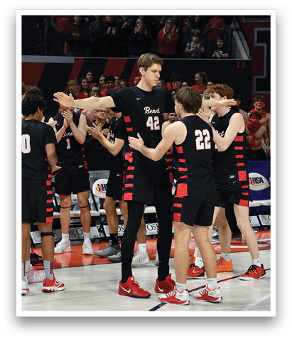 A group of men in black jerseys hugging each other on a basketball court. AI generated content