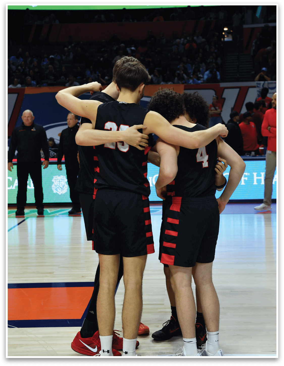 A group of people hugging on a basketball court. AI generated content