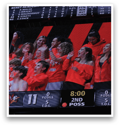 A group of people are watching a game on a large screen. AI generated content
