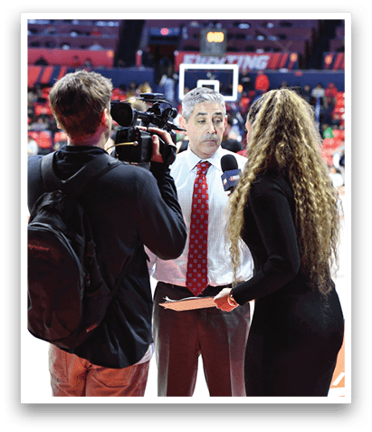 A man and woman are talking to each other on a basketball court. The woman is wearing a black dress. AI generated content