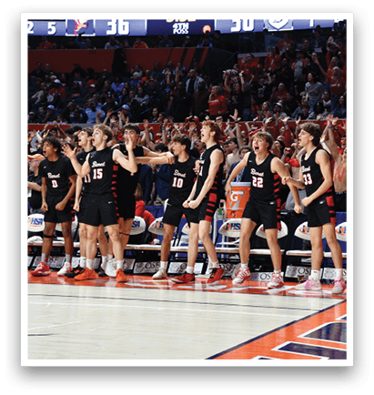 A group of young men in black and red uniforms are standing on a basketball court, celebrating a victory. AI generated content