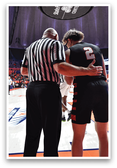 Two men are on a basketball court, one of them is wearing a referee's shirt. AI generated content