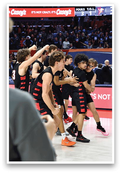 A group of men in black jerseys hugging each other on a basketball court. AI generated content