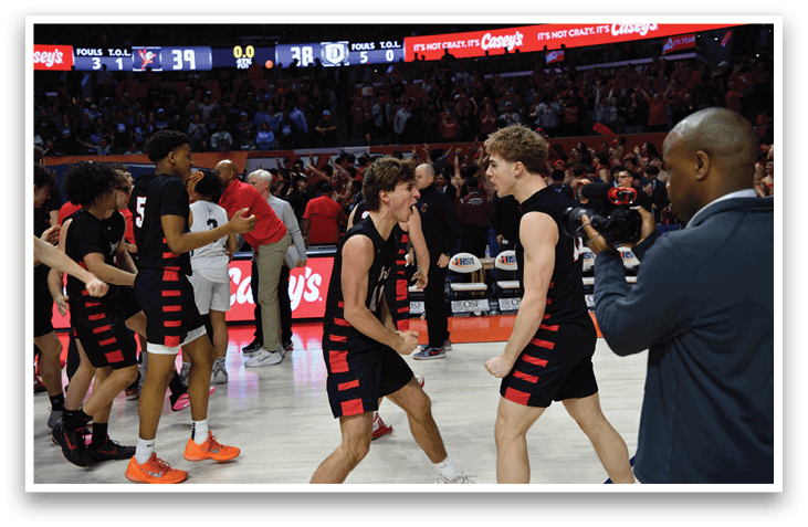 Two men in black shorts are hugging each other on a basketball court. AI generated content
