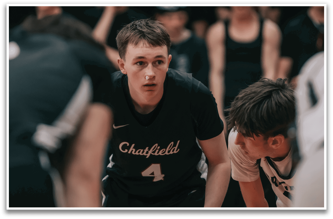 A group of people are playing basketball, with one man wearing a Chatham jersey. AI generated content