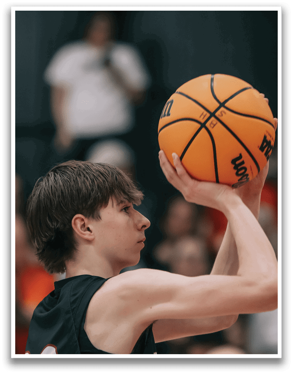 Two men are playing basketball, one of them is wearing a black shirt with the word Chapel on it. AI generated content